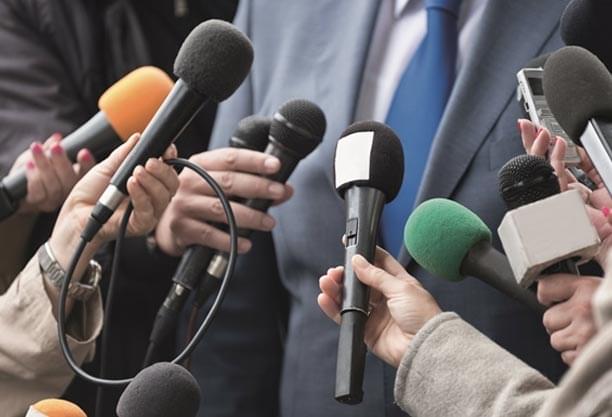 Close-up of multiple news microphones