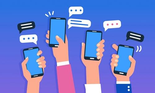 Illustration of hands holding smartphones with text message bubbles for mobile giving