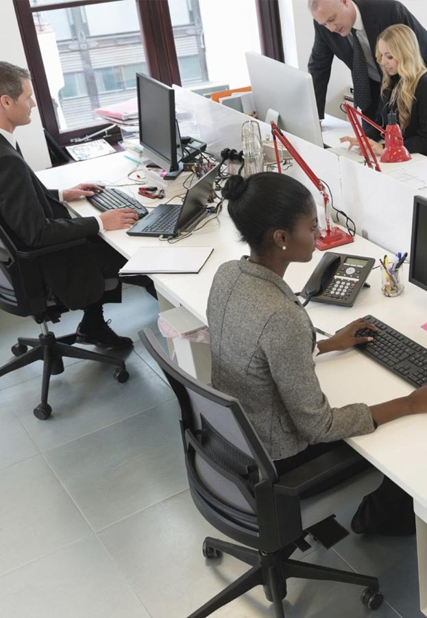 Overhead view of people working at desks in an office environment